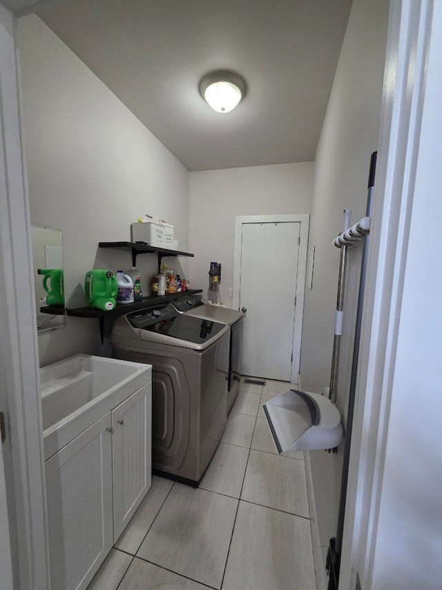 473 Meadow Rd, Inman, SC 29349 - laundry area featuring washing machine and dryer, cabinet space, and light tile patterned floors