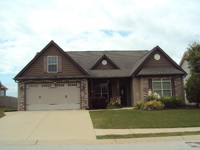 108 Dewfield Ln, Boiling Springs, SC 29316 - craftsman house featuring driveway, a front yard, and stone siding