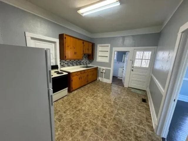 1145 Granite St, Pacolet, SC 29372 - kitchen featuring white appliances, brown cabinetry, and light countertops