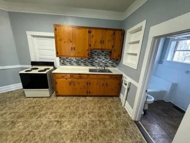 1145 Granite St, Pacolet, SC 29372 - kitchen featuring white electric range, brown cabinets, light countertops, and tasteful backsplash