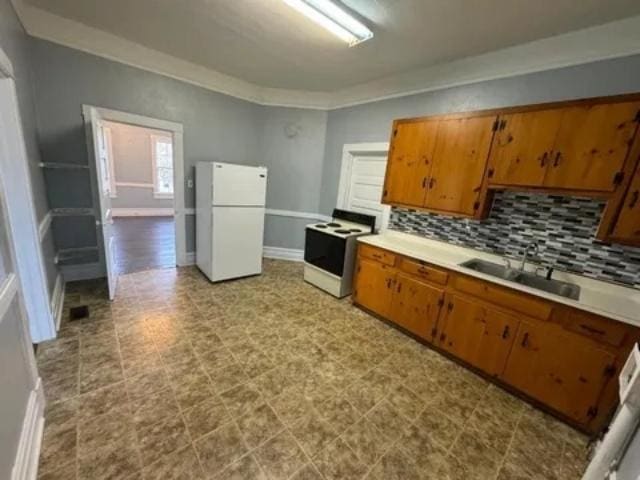 1145 Granite St, Pacolet, SC 29372 - kitchen with white appliances, brown cabinets, decorative backsplash, light countertops, and tile patterned floors