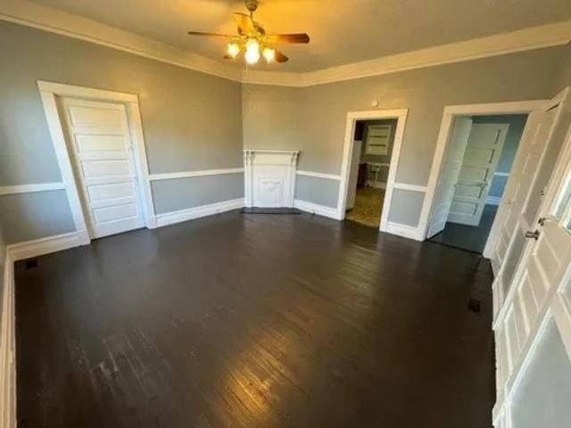 1145 Granite St, Pacolet, SC 29372 - unfurnished living room featuring dark wood-style flooring, a ceiling fan, and crown molding