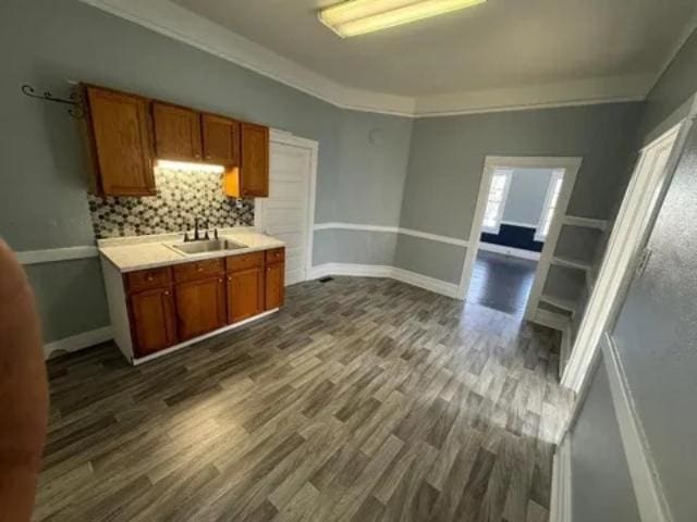 1145 Granite St, Pacolet, SC 29372 - kitchen with dark wood-style flooring, light countertops, decorative backsplash, and brown cabinets