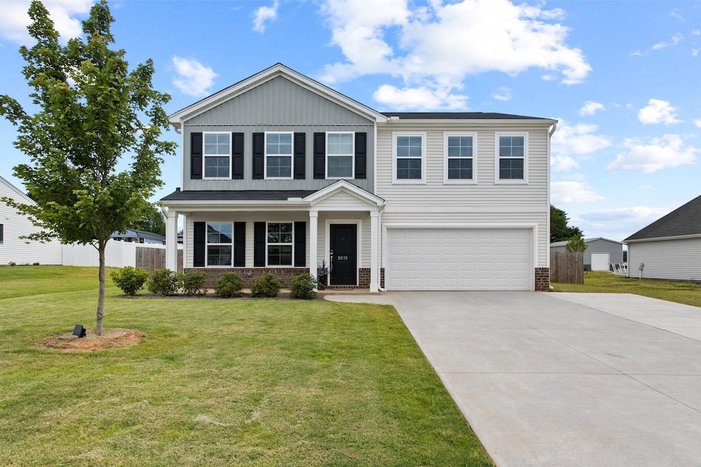 2019 Maggie Acres Rd, Chesnee, SC 29323 - traditional home featuring brick siding, a garage, concrete driveway, board and batten siding, and covered porch