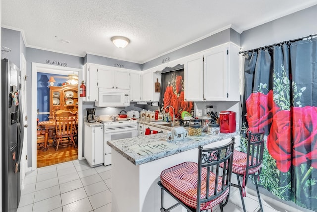 125 Greenway Ave, Union, SC 29379 - kitchen featuring white appliances, a peninsula, crown molding, white cabinets, and a textured ceiling