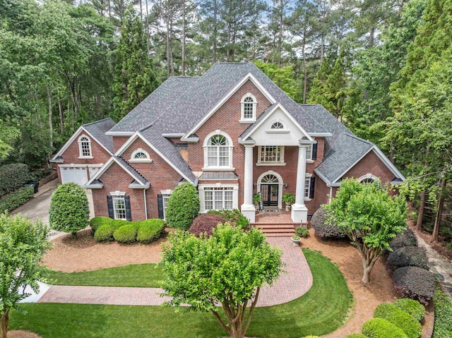 458 Carolina Club Dr, Spartanburg, SC 29306 - greek revival inspired property featuring brick siding, a shingled roof, and a garage