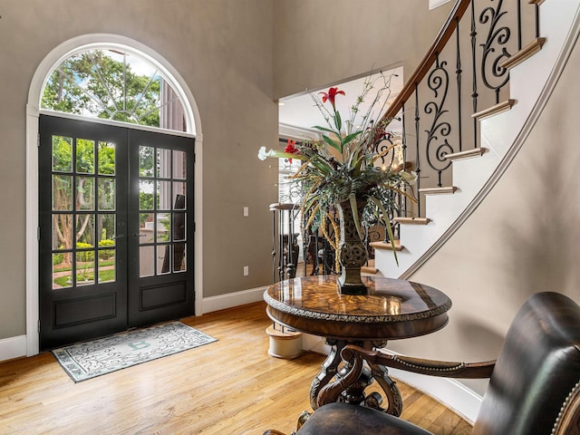 458 Carolina Club Dr, Spartanburg, SC 29306 - entrance foyer with french doors, light wood-type flooring, stairs, and a towering ceiling