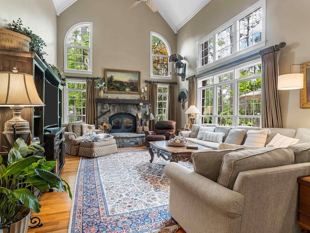 458 Carolina Club Dr, Spartanburg, SC 29306 - living area with high vaulted ceiling, crown molding, light wood-type flooring, a fireplace, and plenty of natural light