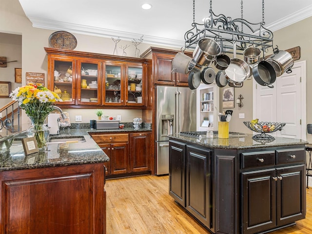 458 Carolina Club Dr, Spartanburg, SC 29306 - kitchen with appliances with stainless steel finishes, light wood-style flooring, ornamental molding, glass insert cabinets, and dark stone counters