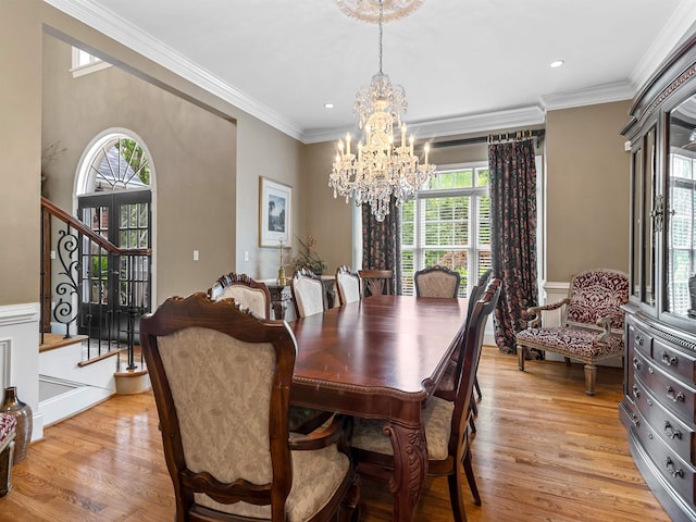 458 Carolina Club Dr, Spartanburg, SC 29306 - dining area featuring a chandelier, healthy amount of natural light, light wood finished floors, stairway, and ornamental molding