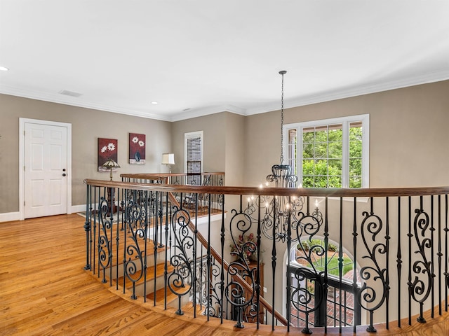 458 Carolina Club Dr, Spartanburg, SC 29306 - hallway featuring wood finished floors, an upstairs landing, recessed lighting, a chandelier, and crown molding