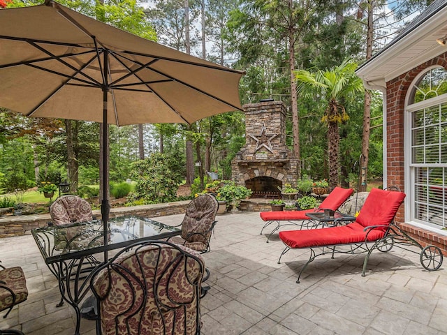 458 Carolina Club Dr, Spartanburg, SC 29306 - view of patio with an outdoor stone fireplace, outdoor dining area, and view of wooded area
