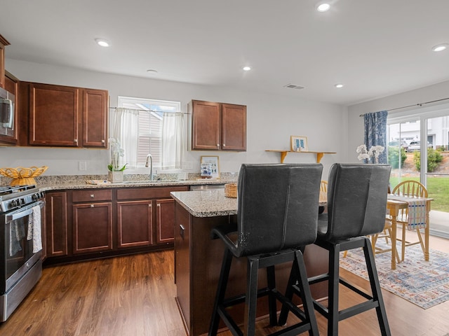 514 Olivia Springs Dr, Spartanburg, SC 29302 - kitchen with appliances with stainless steel finishes, healthy amount of natural light, a kitchen bar, dark wood-style flooring, and recessed lighting