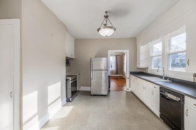 91 Lawrence St, Lyman, SC 29365 - kitchen featuring stainless steel appliances, dark countertops, white cabinetry, and hanging light fixtures