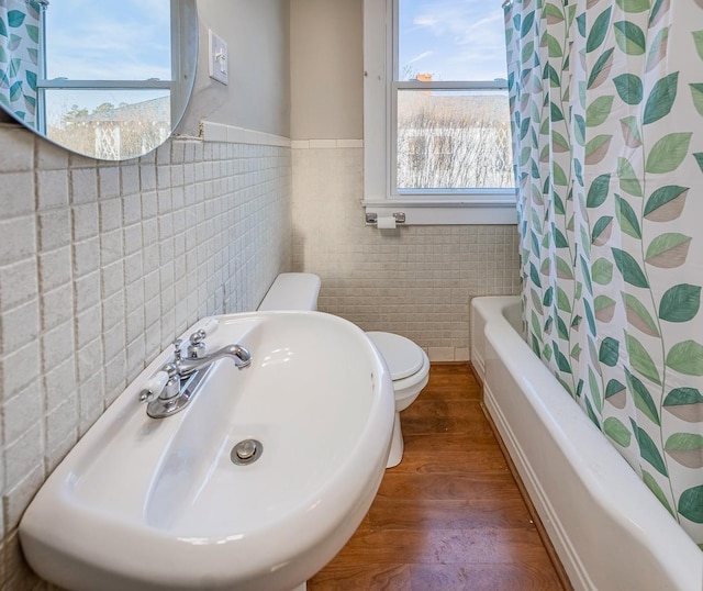 91 Lawrence St, Lyman, SC 29365 - bathroom featuring tile walls, wood finished floors, shower / bathtub combination with curtain, and wainscoting