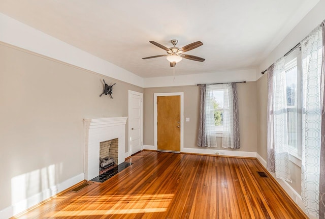 91 Lawrence St, Lyman, SC 29365 - unfurnished living room featuring wood-type flooring, a ceiling fan, and a brick fireplace