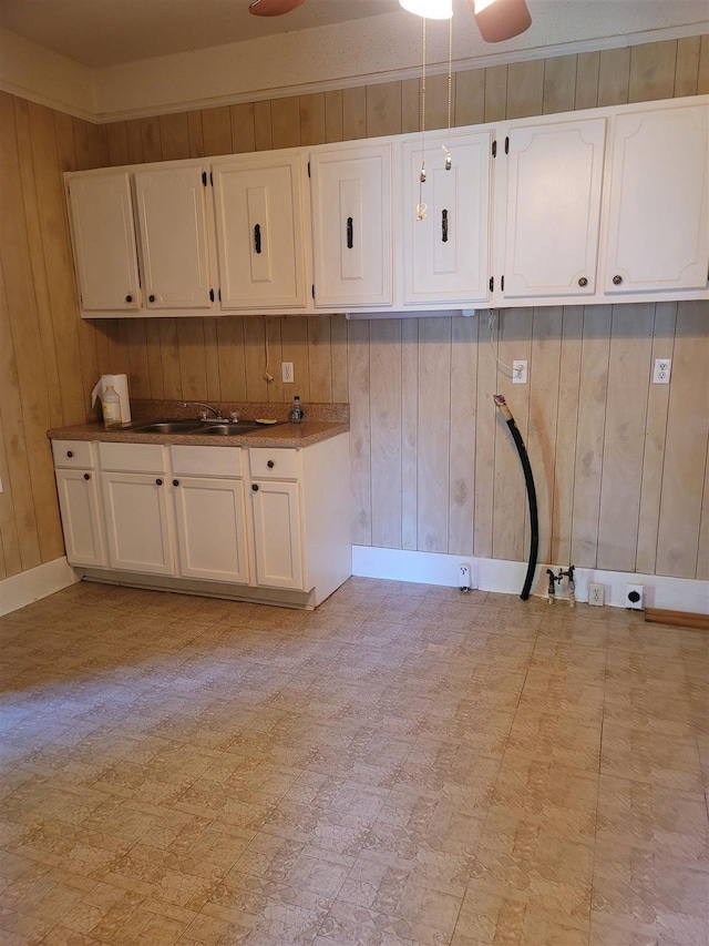 225 Limestone St, Pacolet, SC 29372 - kitchen featuring wooden walls, white cabinetry, a ceiling fan, and light flooring