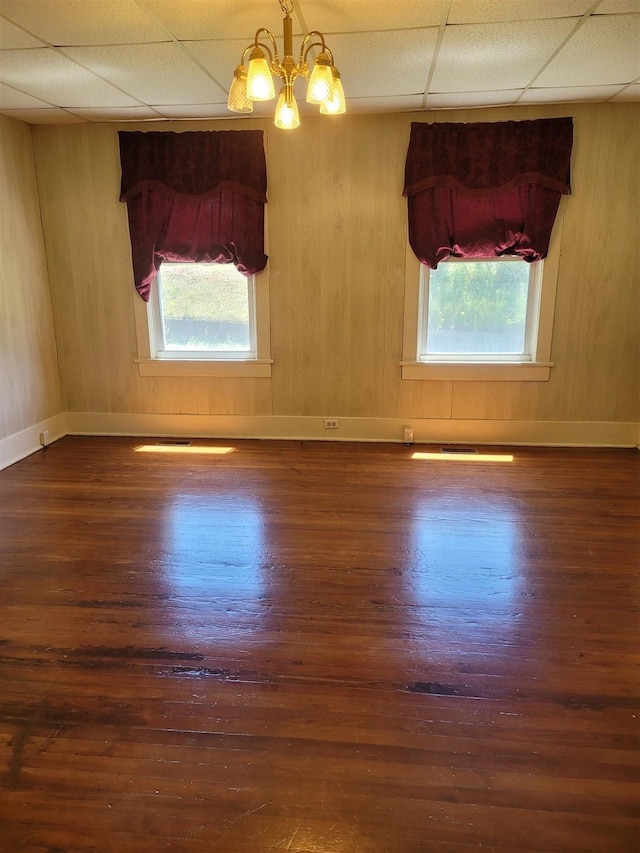 225 Limestone St, Pacolet, SC 29372 - spare room with a paneled ceiling, wood finished floors, a chandelier, and wooden walls