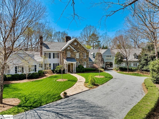 735 Jackson Grove Rd, Landrum, SC 29356 - view of front of home featuring stone siding, a chimney, and a front lawn
