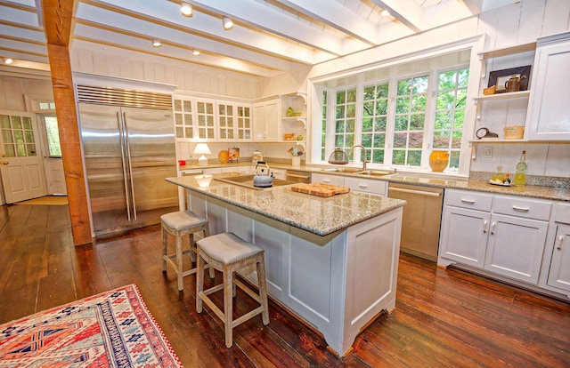 735 Jackson Grove Rd, Landrum, SC 29356 - kitchen with stainless steel appliances, open shelves, dark wood-style floors, a center island, and beam ceiling