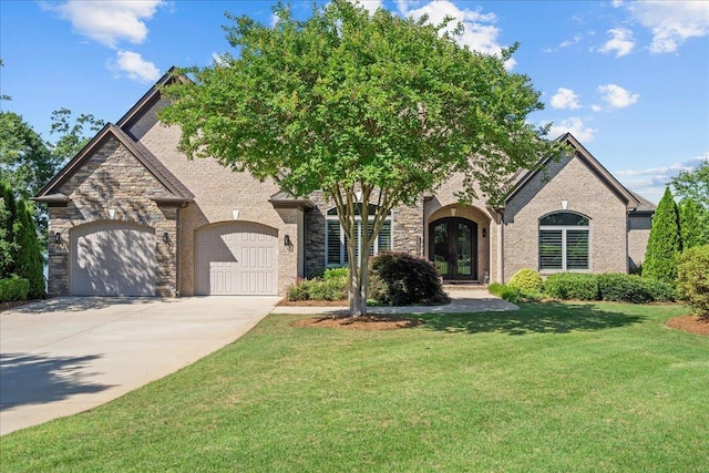 135 Neal Pointe Dr, Chesnee, SC 29323 - view of front of house with french doors, a front yard, an attached garage, driveway, and stone siding