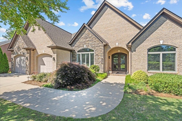135 Neal Pointe Dr, Chesnee, SC 29323 - french country inspired facade with french doors, an attached garage, concrete driveway, and stone siding