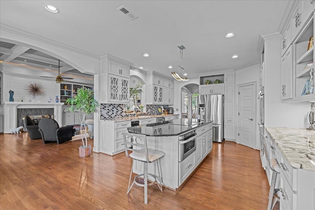 135 Neal Pointe Dr, Chesnee, SC 29323 - kitchen with stainless steel refrigerator with ice dispenser, arched walkways, a ceiling fan, white cabinets, and a center island