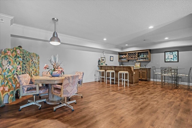 135 Neal Pointe Dr, Chesnee, SC 29323 - dining room with bar with sink, crown molding, a textured ceiling, wood finished floors, and recessed lighting