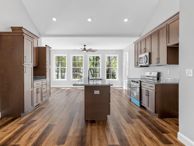 1328 Shoresbrook Rd, Spartanburg, SC 29301 - kitchen featuring appliances with stainless steel finishes, lofted ceiling, healthy amount of natural light, a ceiling fan, and dark stone counters