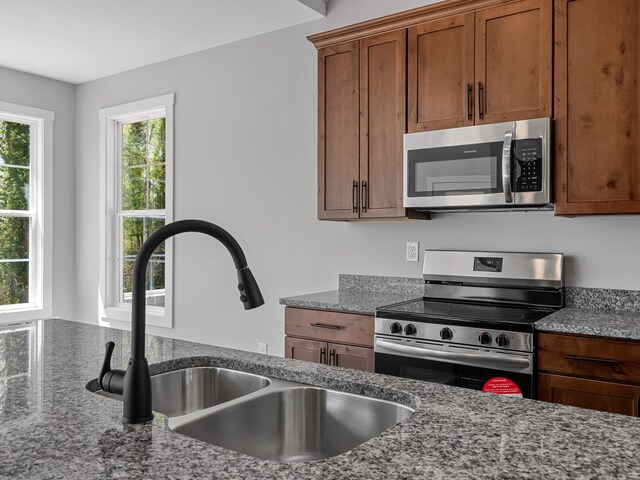 1328 Shoresbrook Rd, Spartanburg, SC 29301 - kitchen featuring appliances with stainless steel finishes, stone counters, and brown cabinets