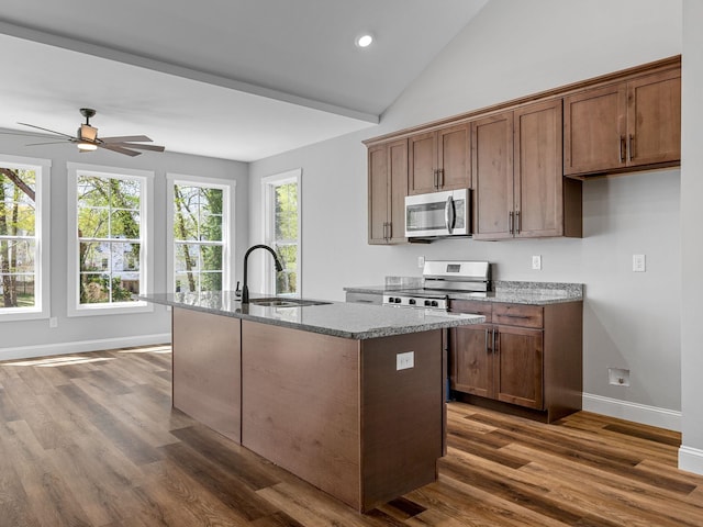 1328 Shoresbrook Rd, Spartanburg, SC 29301 - kitchen featuring stainless steel appliances, dark wood-style floors, a center island with sink, ceiling fan, and light stone counters
