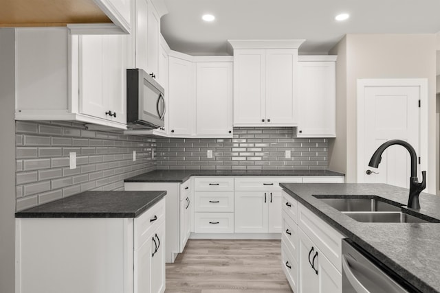 3135 E Croft Cir, Spartanburg, SC 29302 - kitchen with appliances with stainless steel finishes, dark countertops, white cabinetry, recessed lighting, and backsplash