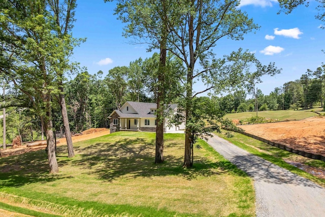 3135 E Croft Cir, Spartanburg, SC 29302 - view of front facade featuring asphalt driveway, a front lawn, stone siding, and view of wooded area
