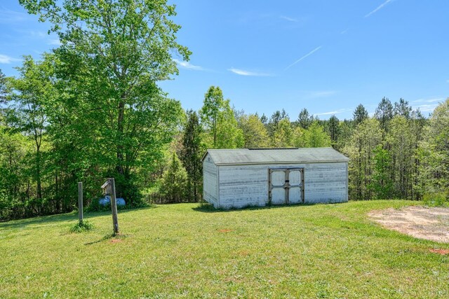 955 Baggett Rd, Enoree, SC 29335 - view of grassy yard with a storage unit and a forest view