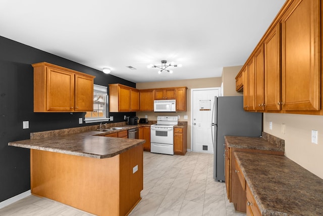 100 Maximus Dr, Greer, SC 29651 - kitchen with stainless steel appliances, a peninsula, light marble finish flooring, brown cabinetry, and dark countertops