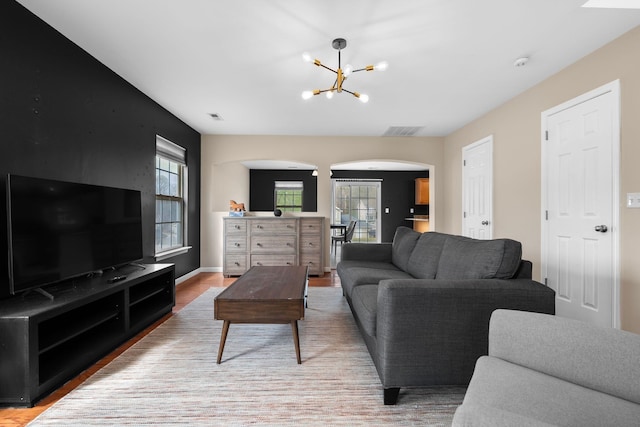 100 Maximus Dr, Greer, SC 29651 - living room with arched walkways, a chandelier, and wood finished floors