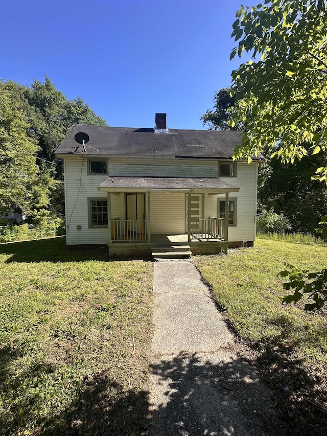 131 Furman St, Enoree, SC 29388 - view of front facade featuring covered porch, a front lawn, and a chimney