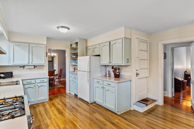 203 E S St, Union, SC 29379 - kitchen with freestanding refrigerator, light wood-style floors, a chandelier, light countertops, and crown molding