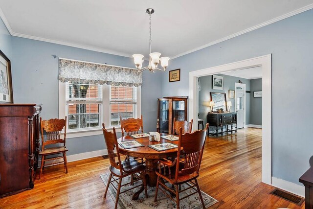 203 E S St, Union, SC 29379 - dining space featuring a chandelier, ornamental molding, and wood finished floors