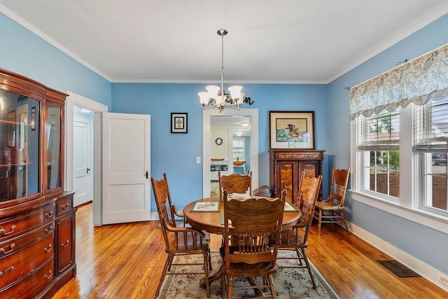 203 E S St, Union, SC 29379 - dining space featuring a chandelier, light wood-style flooring, and ornamental molding