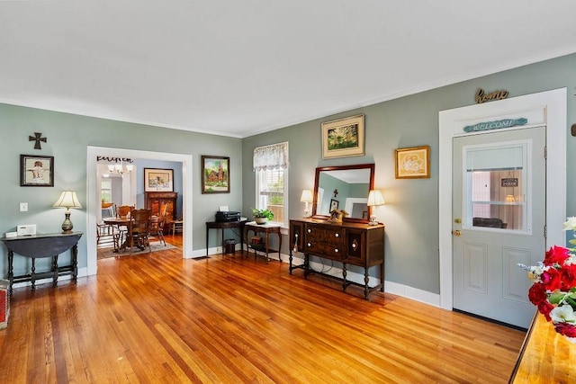 203 E S St, Union, SC 29379 - foyer featuring light wood finished floors, a chandelier, and ornamental molding