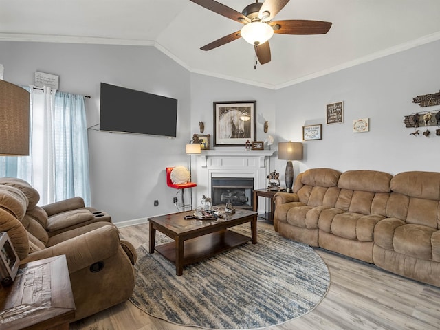 110 Hidden Ridge Dr, Spartanburg, SC 29301 - living room featuring ceiling fan, vaulted ceiling, a glass covered fireplace, ornamental molding, and wood finished floors
