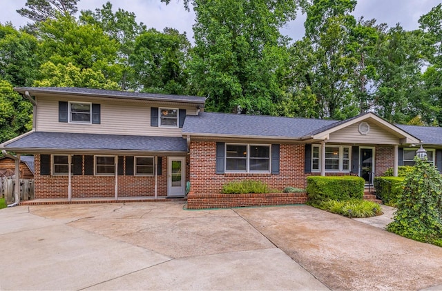 2250 Hickory Dr, Spartanburg, SC 29302 - split level home with brick siding, a shingled roof, and a porch