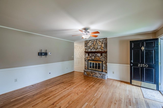 2250 Hickory Dr, Spartanburg, SC 29302 - unfurnished living room with a ceiling fan, wood finished floors, ornamental molding, and a stone fireplace
