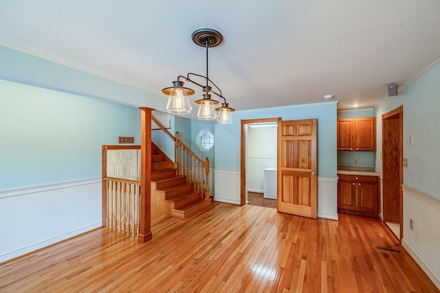 2250 Hickory Dr, Spartanburg, SC 29302 - spare room with light wood-type flooring, stairway, and crown molding