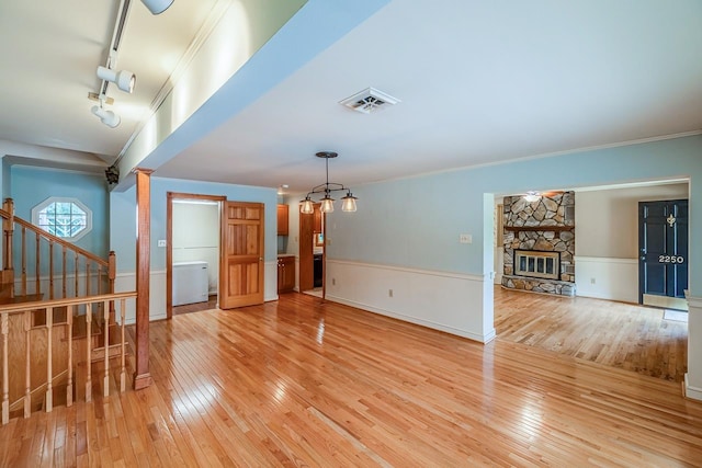 2250 Hickory Dr, Spartanburg, SC 29302 - unfurnished room with light wood-type flooring, a fireplace, stairway, ornamental molding, and track lighting