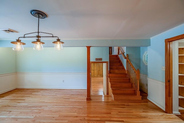 2250 Hickory Dr, Spartanburg, SC 29302 - stairway featuring ornamental molding, wood finished floors, and wainscoting