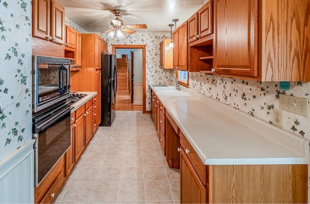 2250 Hickory Dr, Spartanburg, SC 29302 - kitchen featuring black appliances, wallpapered walls, a ceiling fan, brown cabinetry, and light countertops