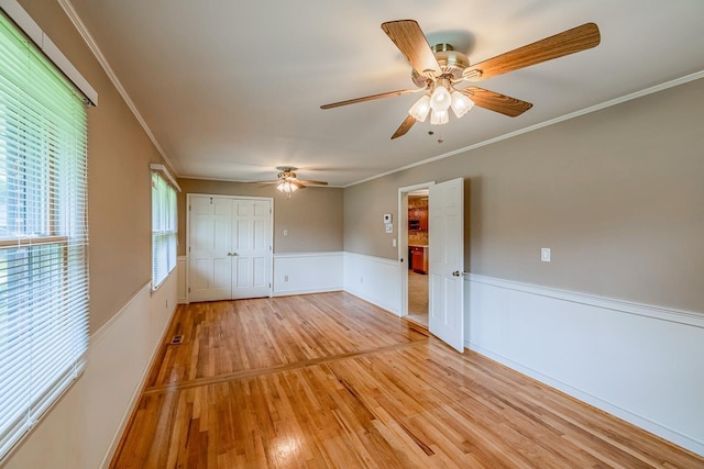 2250 Hickory Dr, Spartanburg, SC 29302 - spare room featuring light wood-type flooring, a wainscoted wall, a ceiling fan, and crown molding
