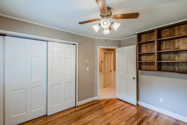 2250 Hickory Dr, Spartanburg, SC 29302 - unfurnished bedroom with light wood-style flooring, a closet, crown molding, and ceiling fan